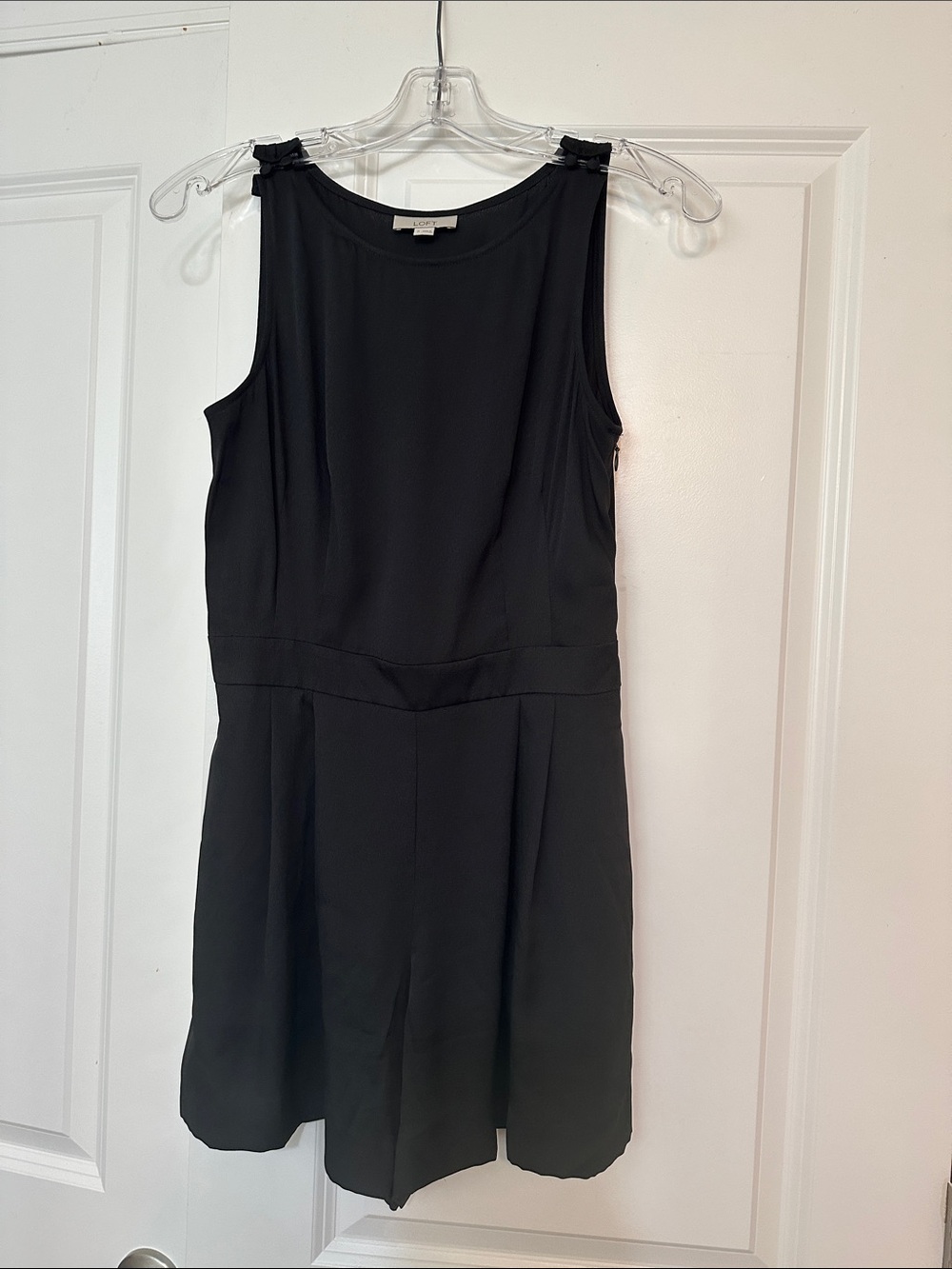 Loft size 0 Black sleeveless romper w/ pleated shorts and side pockets side zip.